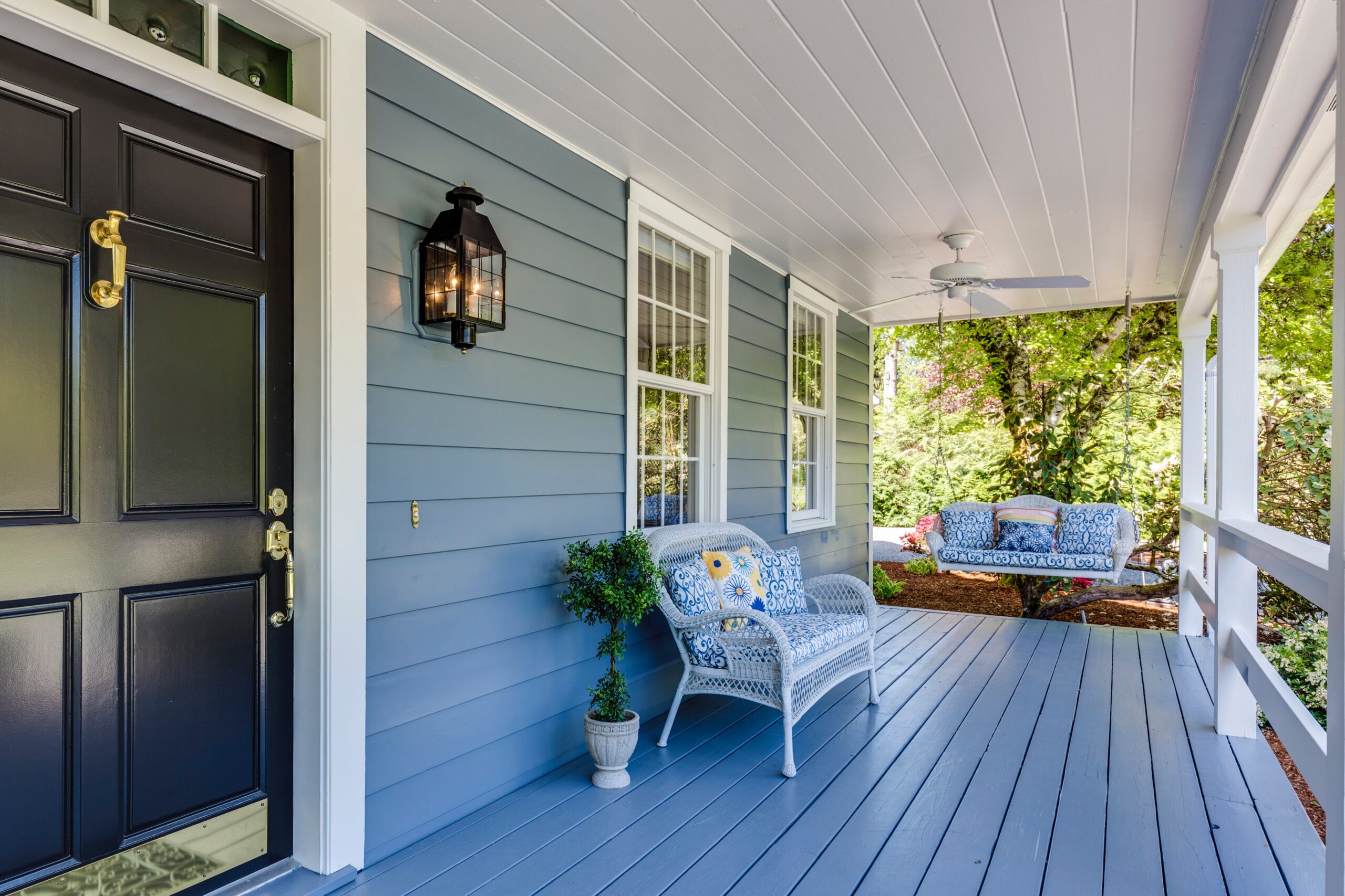 Newly renovated outdoor patio. Modern sconce, repainted door, house number, modern bench. Accent colors to highlight home.